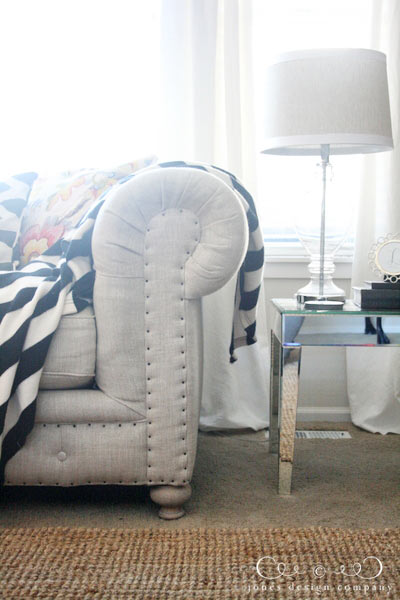 tufted-linen-sofa-with-mirrored-side-table